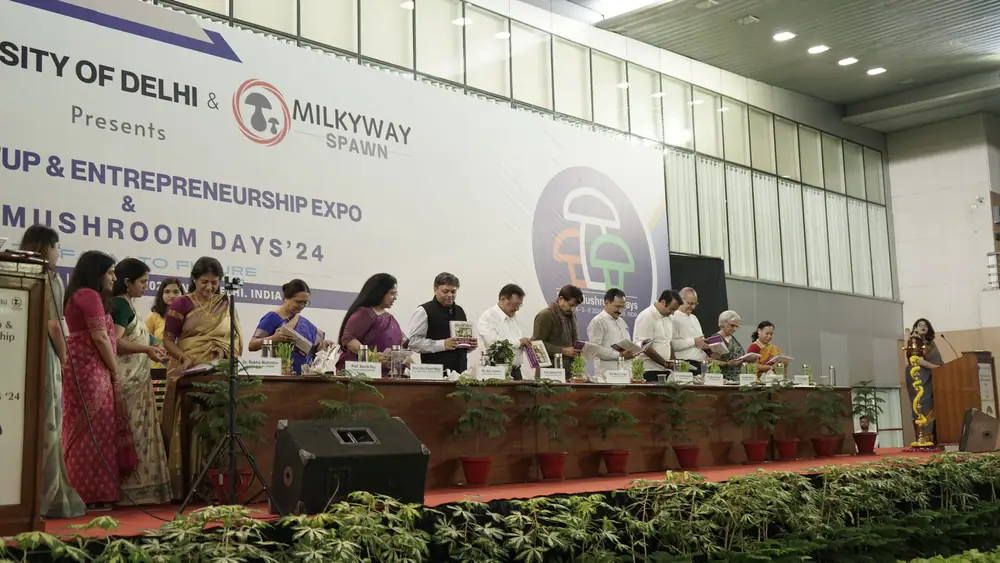 The inauguration panel on stage with the ceremonial planting